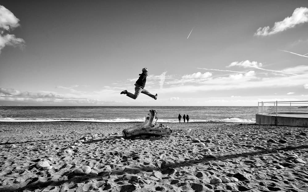 Joyful Beach Leap by Carlo Ferrara — canvas wall art