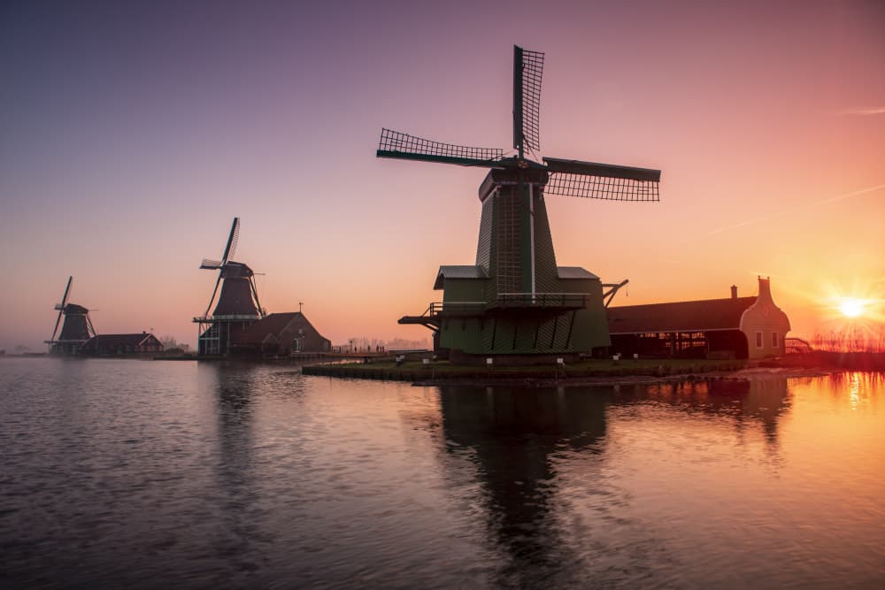 Dutch Windmills Sunrise Glow by JUAN CARLOS HERVÁS MARTÍNEZ — canvas wall art