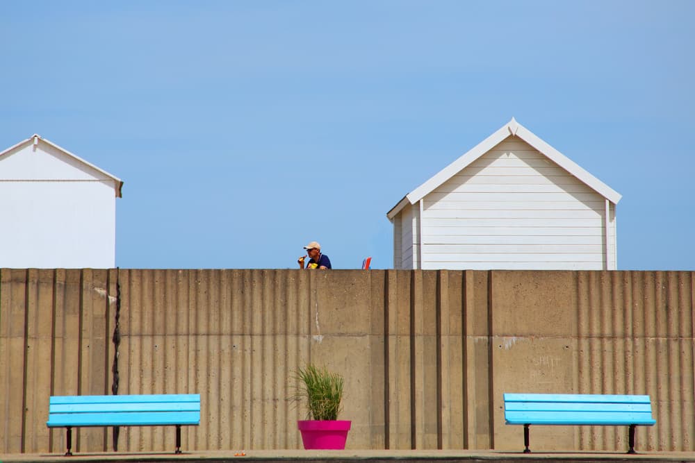 Man Watching Beach Huts by Massimo Della Latta — canvas wall art