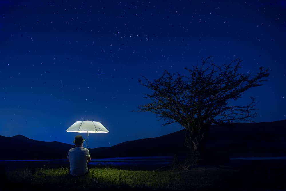 Man Under Glowing Umbrella by Jesus Concepcion Alvarado — canvas wall art