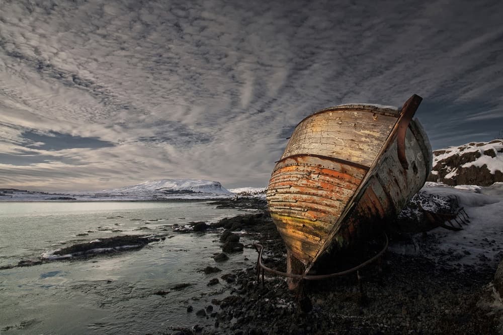 Weathered Boat Snowy Coast by Þorsteinn H. Ingibergsson — canvas wall art