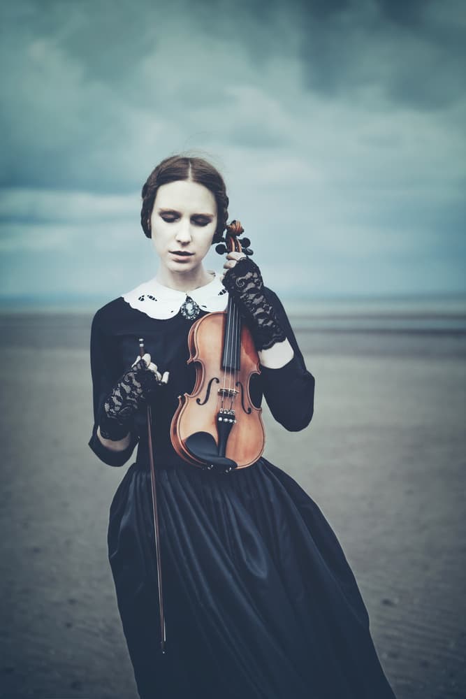Pensive Violinist on Shore by Magdalena Russocka — canvas wall art