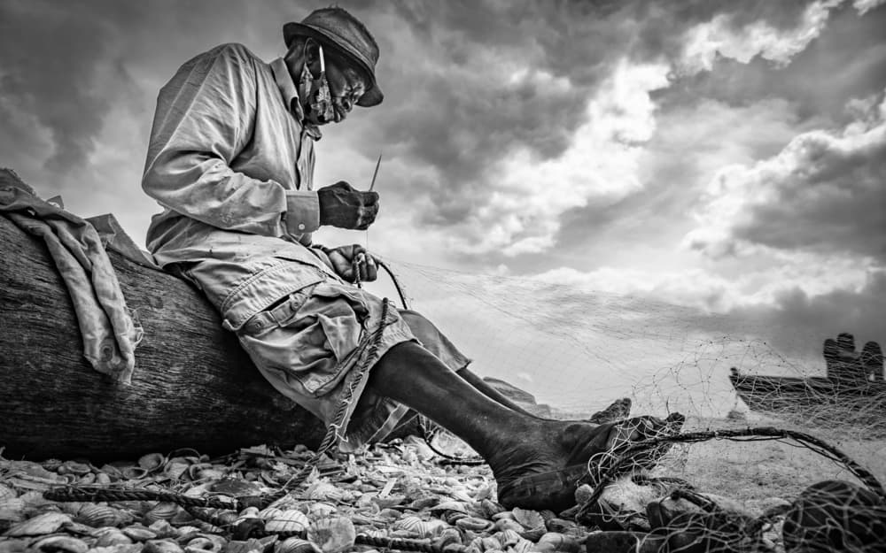 Old Fisherman Mending Net by João Coelho — canvas wall art