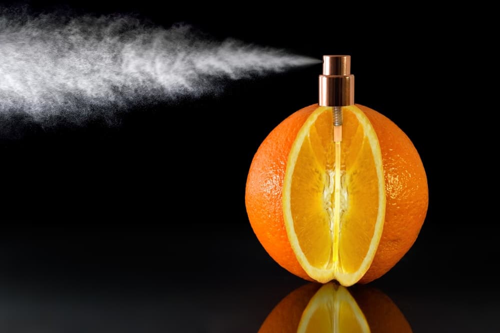 Orange Perfume Spray by Jesús M. García — canvas wall art