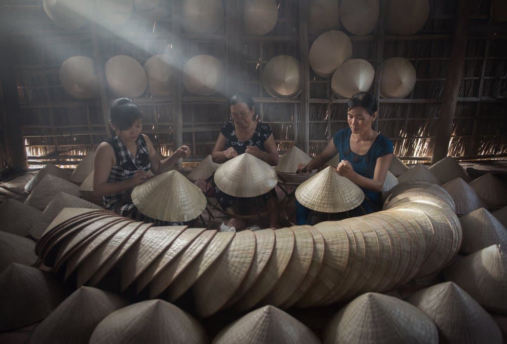Sunlit Vietnamese Hat Workshop by Sarawut Intarob — canvas wall art
