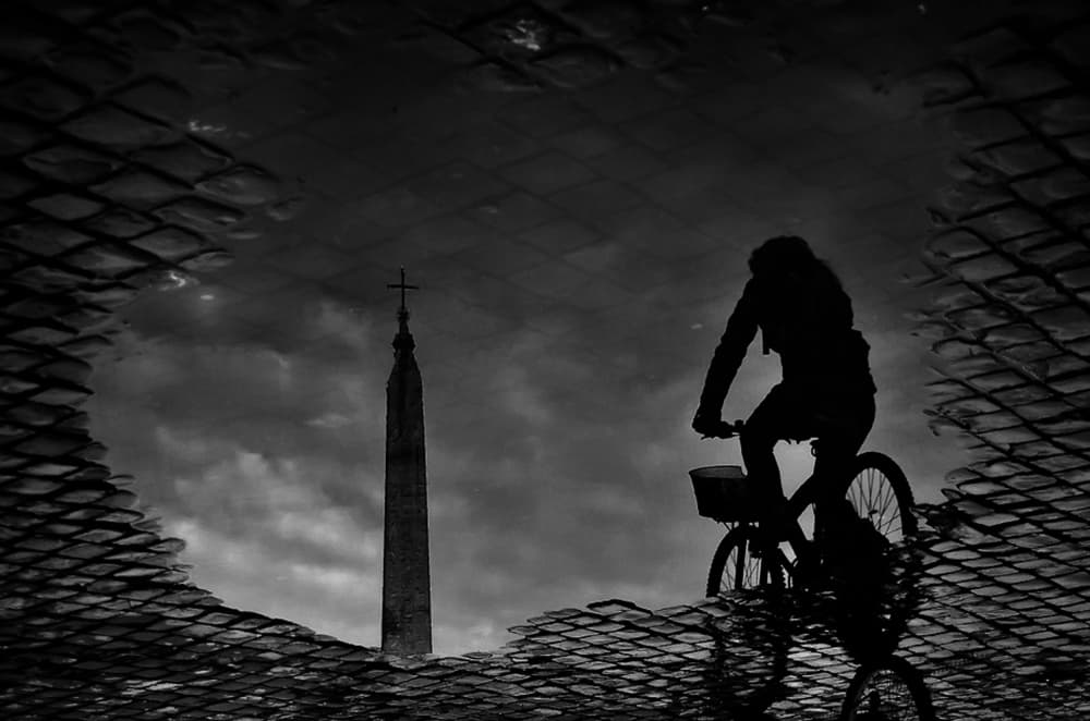 Cyclist Obelisk Puddle Reflection by Antonio Grambone — canvas wall art