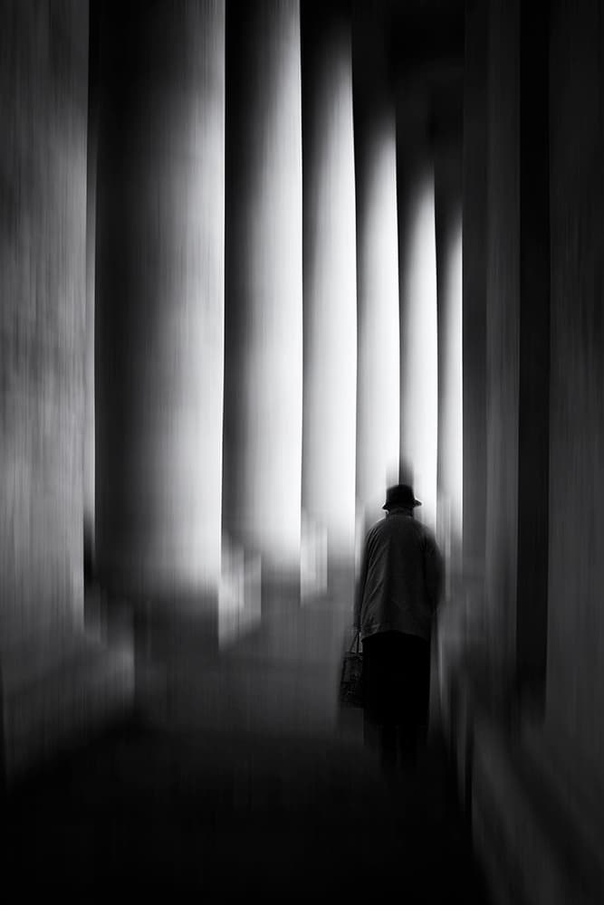 Solitary Figure Among Columns by Massimo Della Latta — canvas wall art