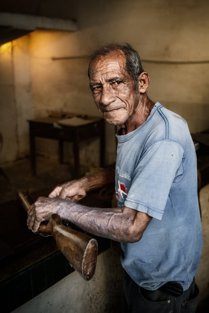 Artisan with Wooden Rifle by Trevor Cole — canvas wall art
