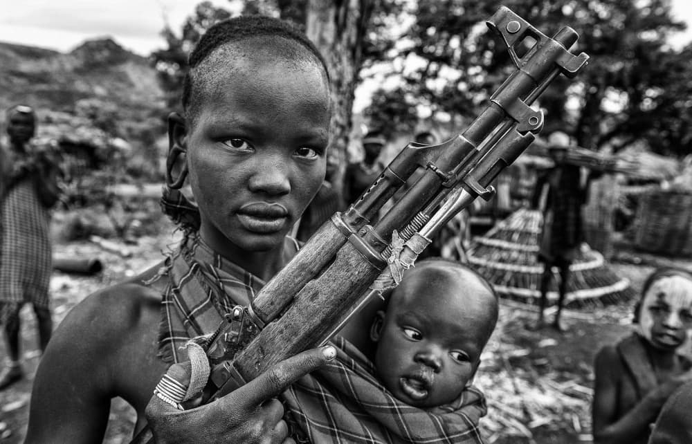African Mother Rifle Baby by Joxe Inazio Kuesta Garmendia — canvas wall art