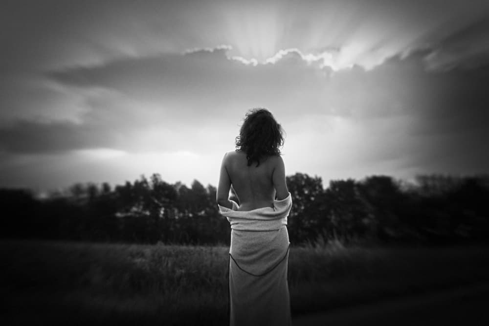 Woman Under Dramatic Sky by Bogdan Bouşcă — canvas wall art