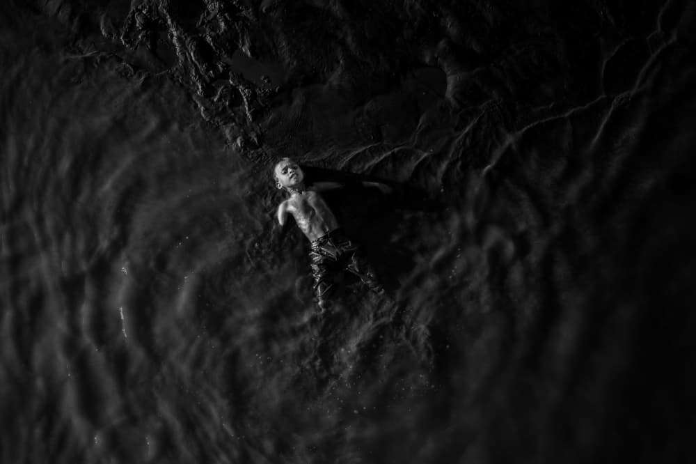 Floating Child Calm Water by Kuntal Biswas — canvas wall art