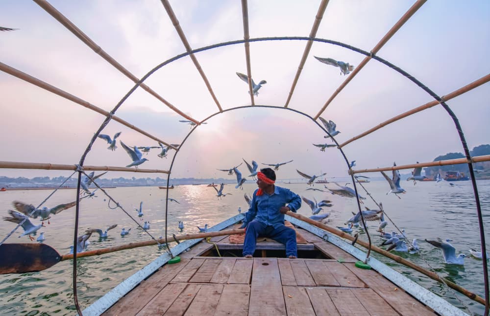 River Boatman and Birds by Ajit Kumar Majhi — canvas wall art