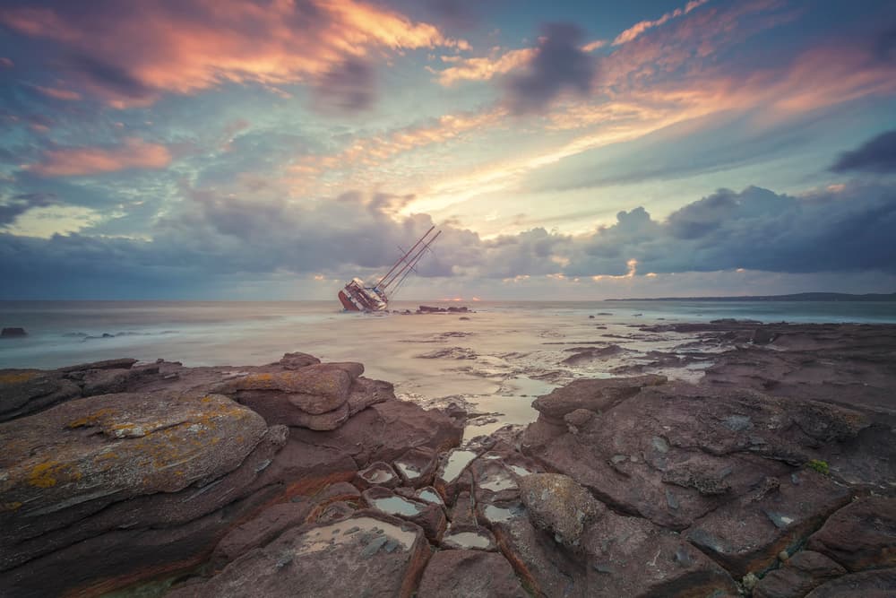 Sunset Shipwreck on Rocks by Daniele Atzori — canvas wall art