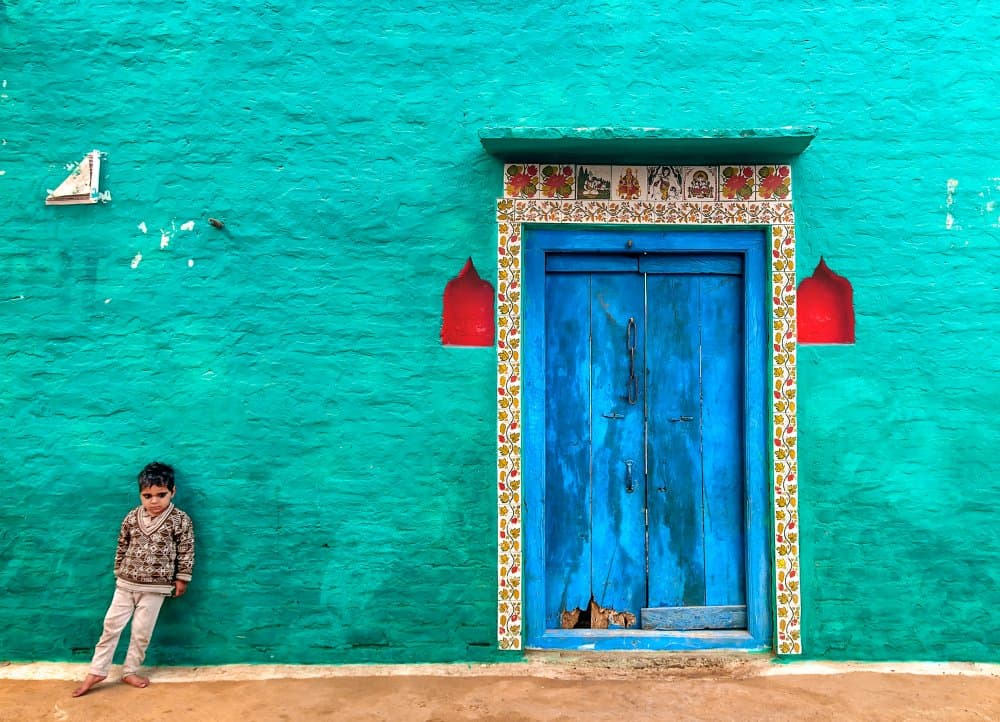 Boy by Blue Door by Jassi Oberai — canvas wall art