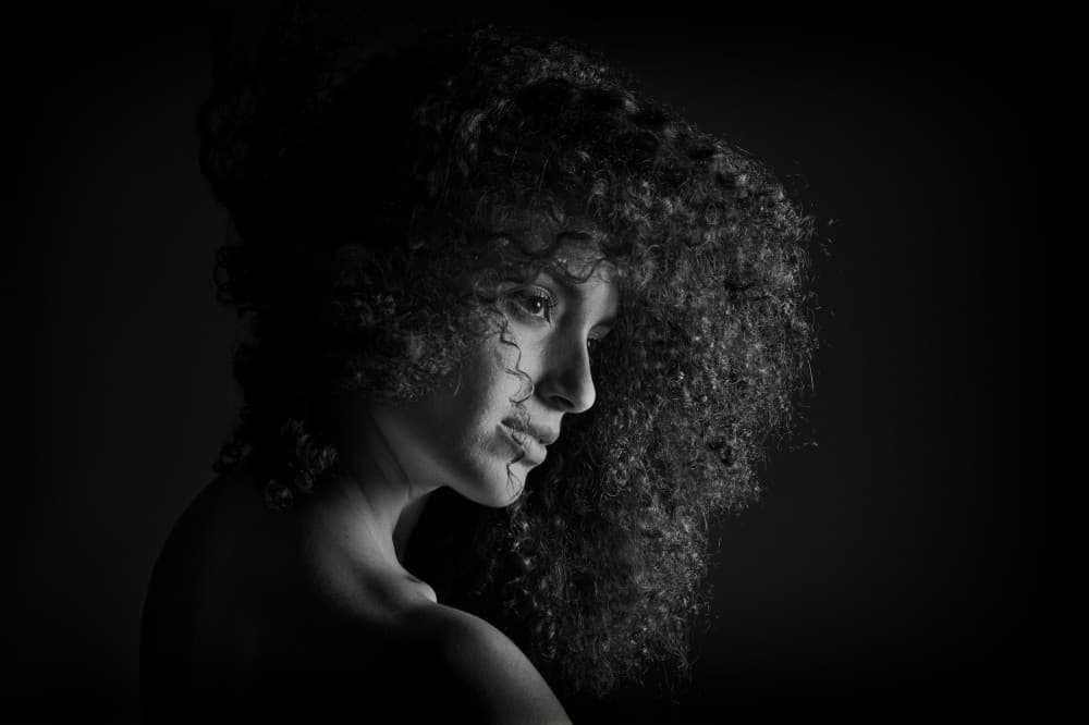 Dramatic Curly Hair Portrait by Joan Gil Raga — canvas wall art