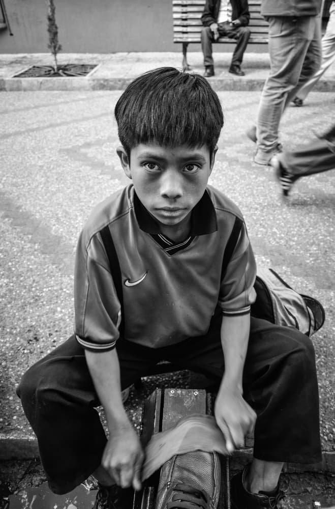 Young Shoe Shiner by Yumian Deng — canvas wall art