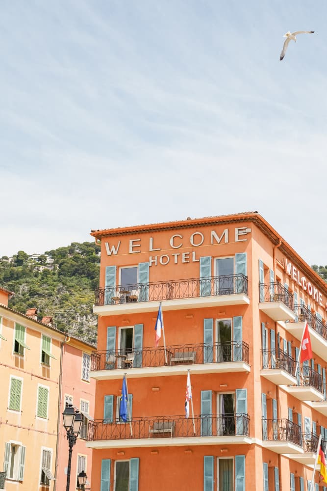 Orange Hotel Blue Shutters by Henrike Schenk — canvas wall art