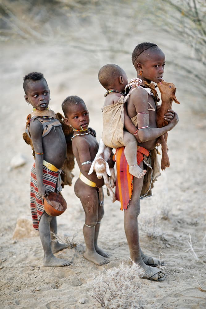 African Children Carrying Goat by Trevor Cole — canvas wall art