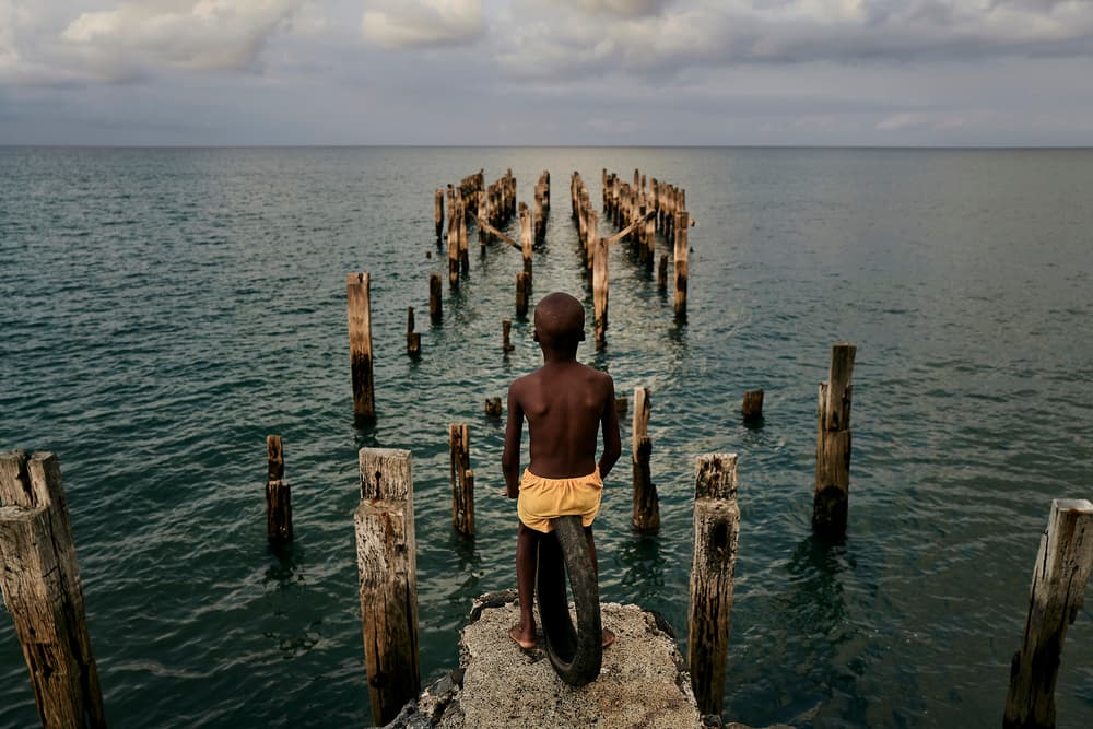 Young Boy Ponders Ocean by Luís Godinho — canvas wall art