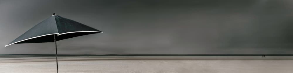 Umbrella on a Moody Beach by Gilbert Claes — canvas wall art