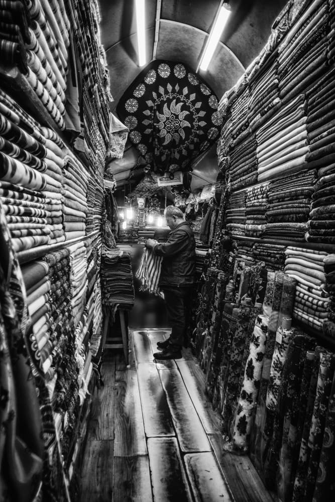 Bazaar Textile Merchant by Pavol Stranak — canvas wall art