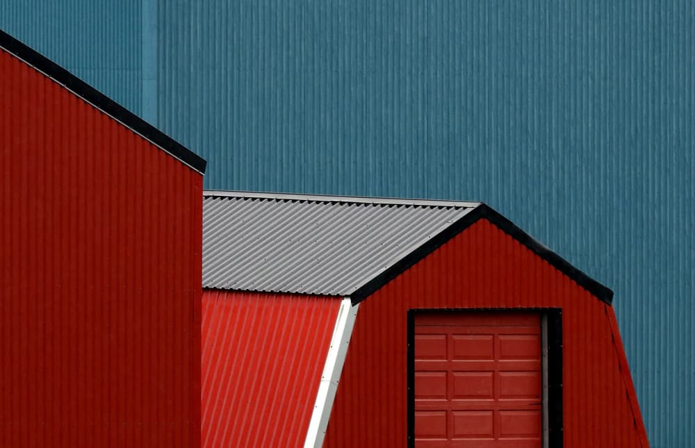 Red Buildings Blue Wall by Hans-Wolfgang Hawerkamp — canvas wall art