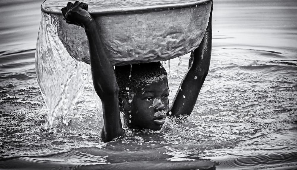 Young Boy Carries Water by Elena Molina — canvas wall art