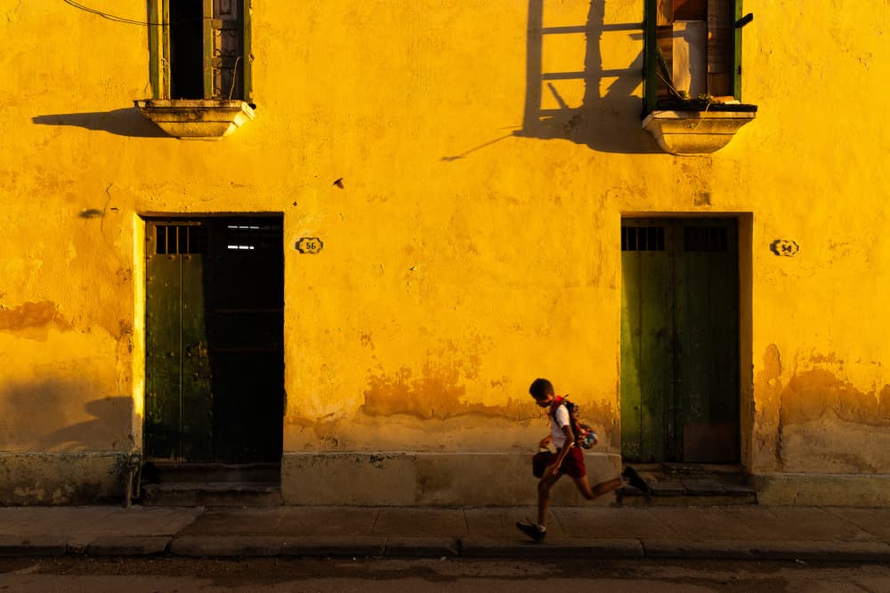 Running Boy Yellow Wall by Tony Xu — canvas wall art