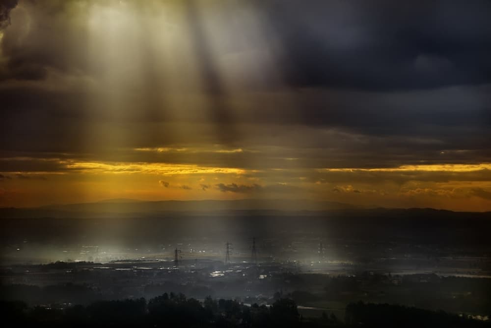 Mystical Sun Rays Over City by Antonio Grambone — canvas wall art