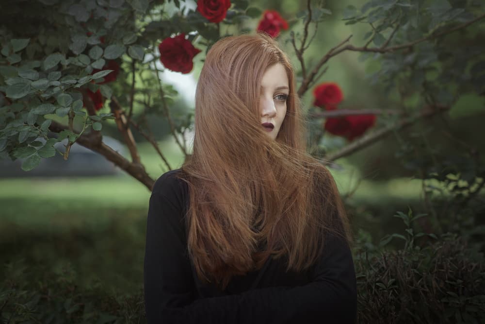 Pensive Woman in Roses by Bobby Kostadinov — canvas wall art