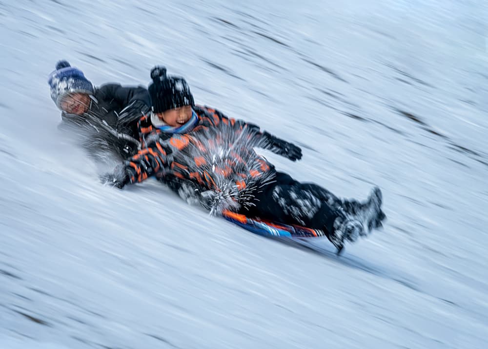 Speedy Kids Sledding by Louie Luo — canvas wall art