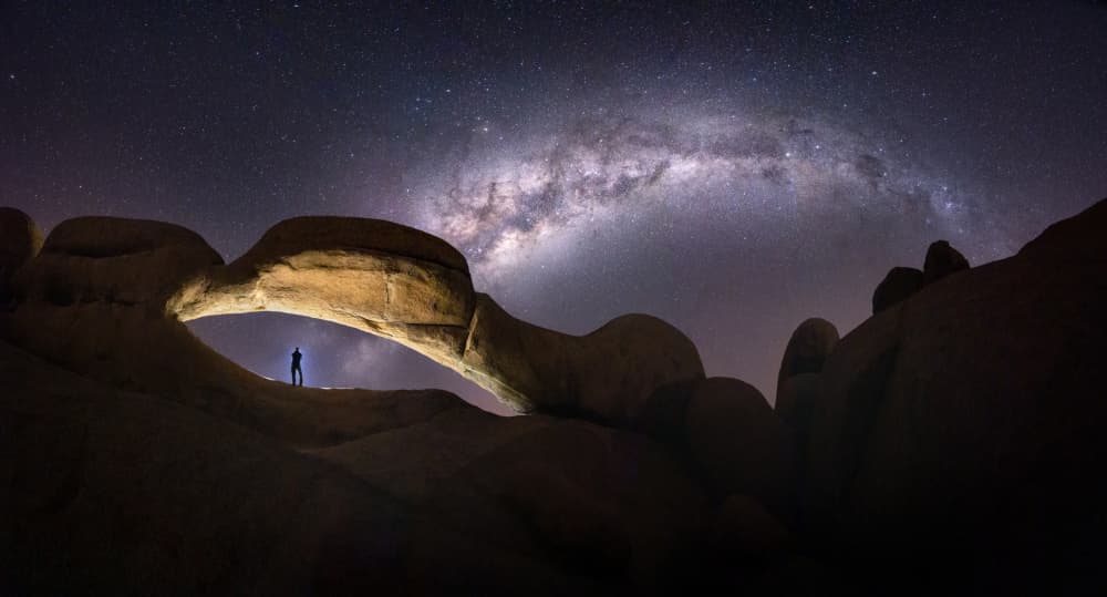 Stargazer Under Arch by Karol Nienartowicz — canvas wall art