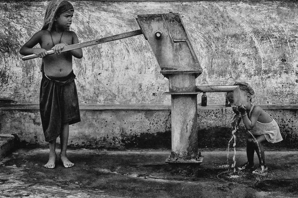 Thirsty Children at Pump by Avishek Das — canvas wall art