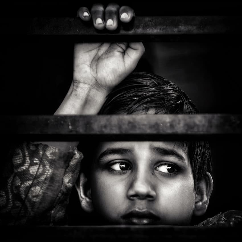Boy Behind Bars by Piet Flour — canvas wall art