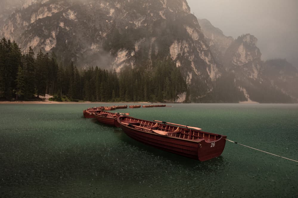 Rainy Alpine Lake Boats by Marco Tagliarino — canvas wall art