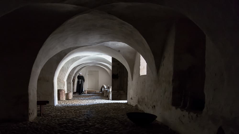 Monk In Arched Hallway by Leif Løndal — canvas wall art