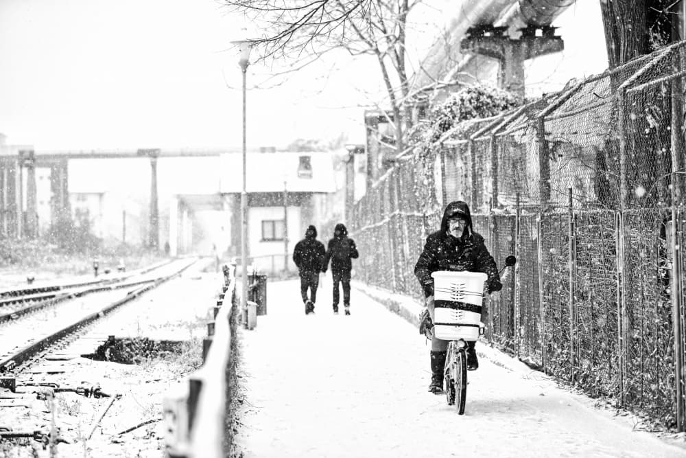 Cyclist in Snowfall by Julien Oncete — canvas wall art