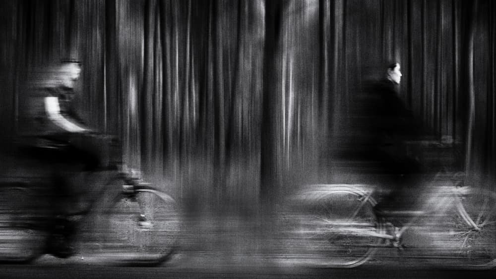 Blurred Forest Cyclists by Normunds Kaprano — canvas wall art