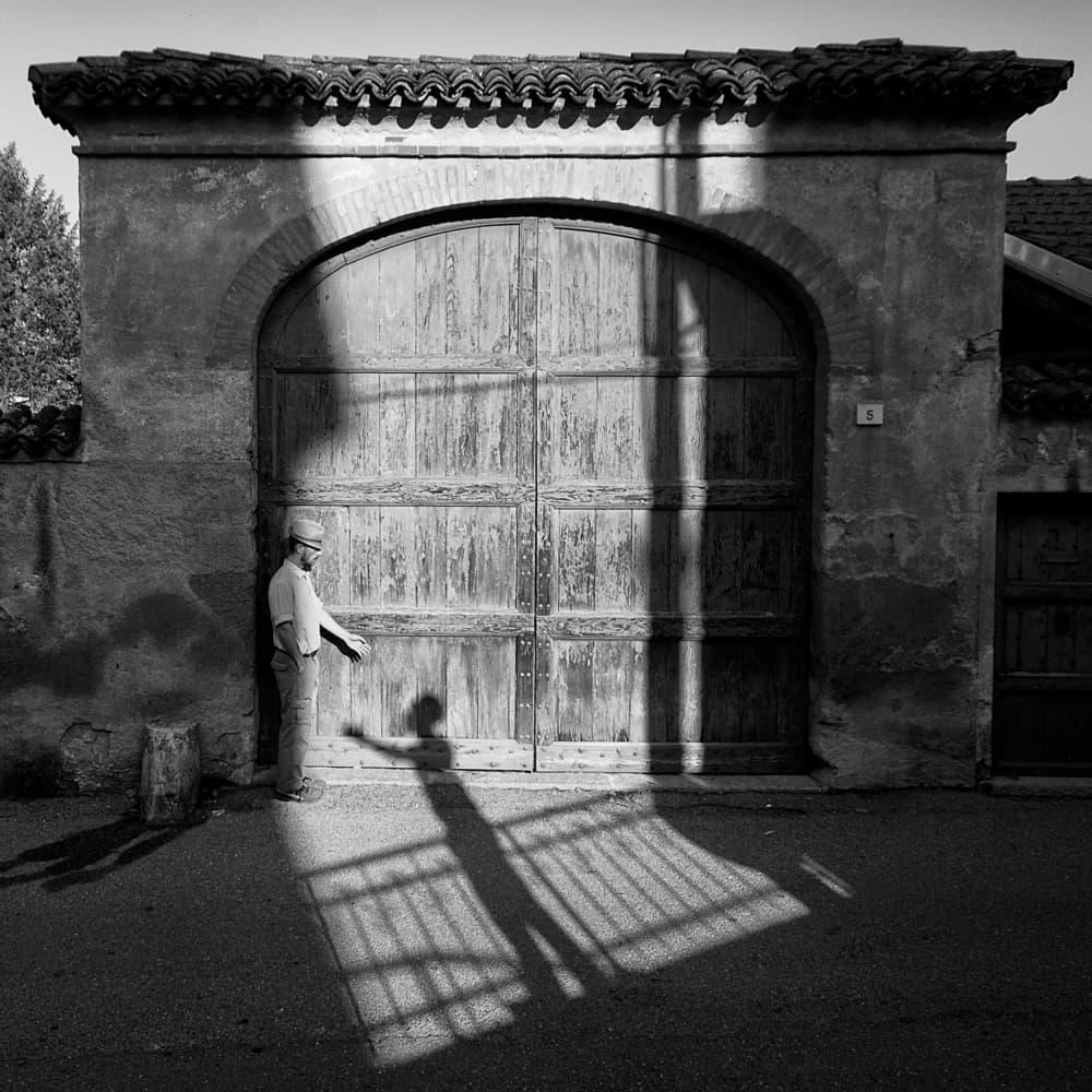Man and Gate Shadows by Carlo Ferrara — canvas wall art