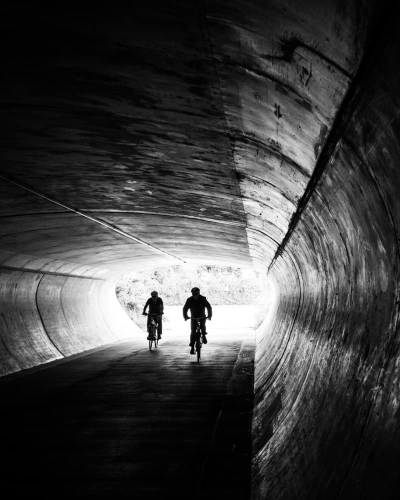 Cyclists Exit Tunnel by Sofie Steenhoudt — canvas wall art