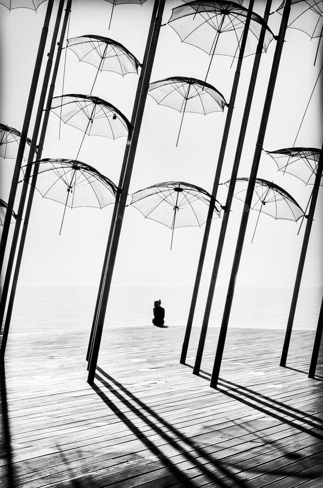 Solitude Under Umbrellas by George Digalakis — canvas wall art