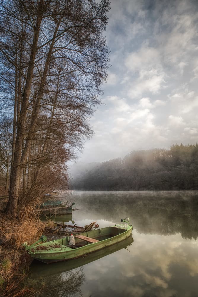 Green Boat On Misty Lake by Guy Krier — canvas wall art