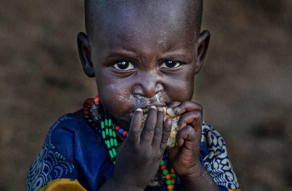 Child Eating Corn by Joxe Inazio Kuesta Garmendia — canvas wall art
