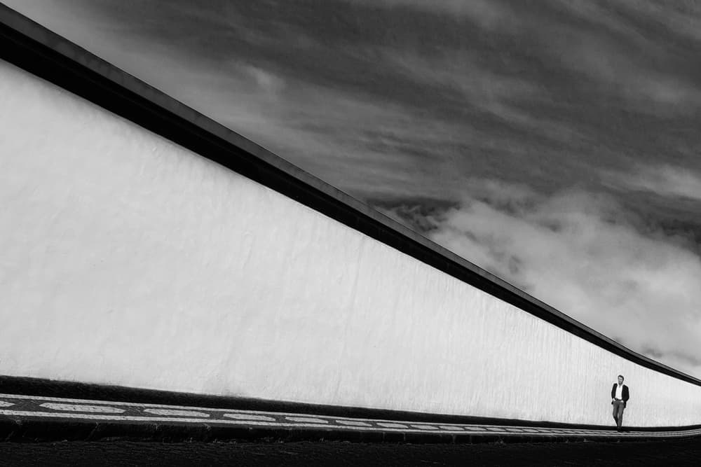 Man Walks Long Wall by Paulo Abrantes — canvas wall art