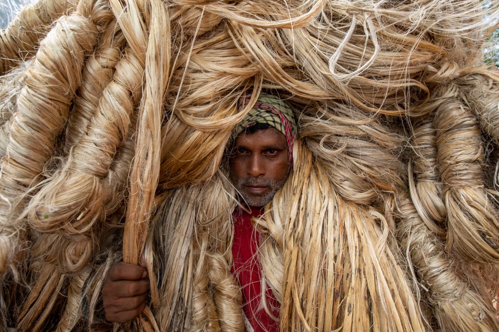 Man With Jute Load by Azim Khan Ronnie — canvas wall art