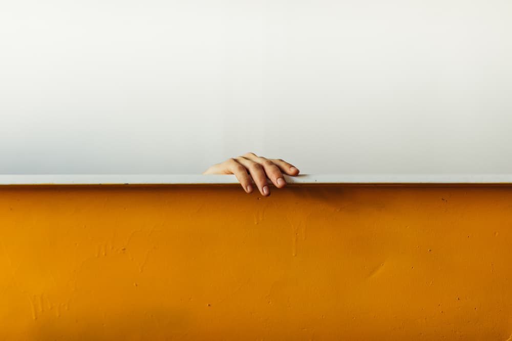 Hand In Orange Bathtub by Javier Pardina — canvas wall art