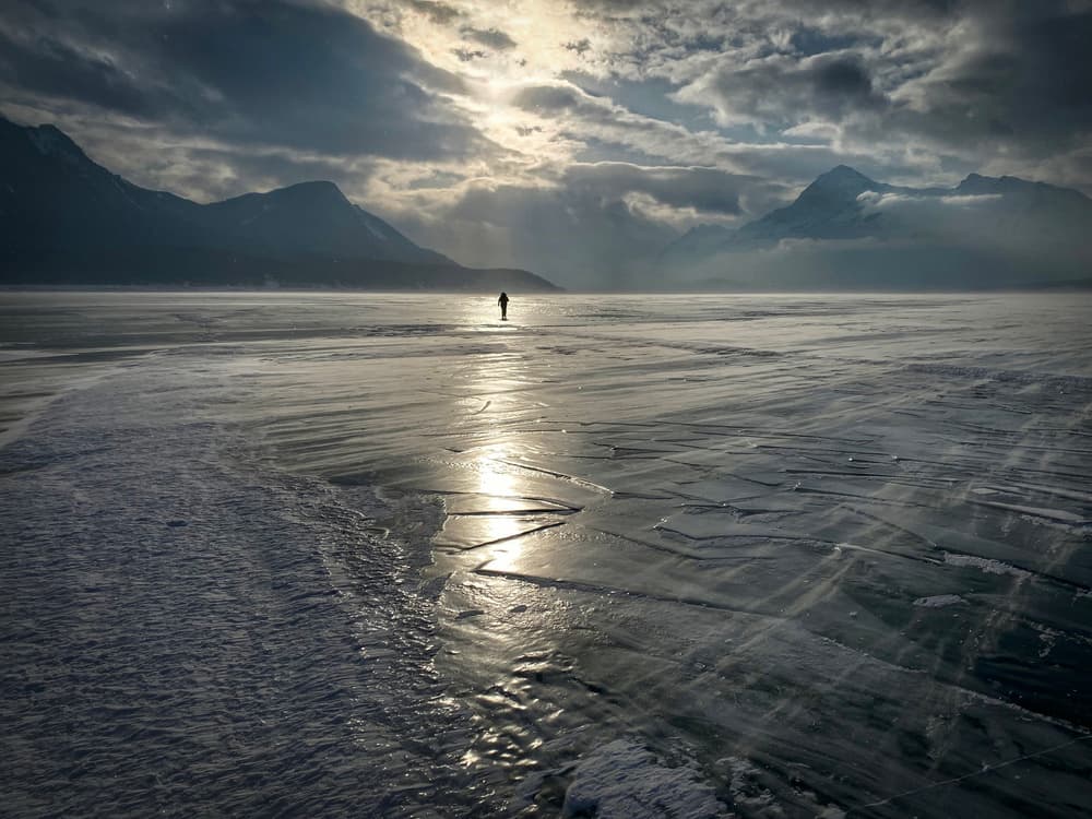 Lone Figure Frozen Lake by James S. Chia — canvas wall art