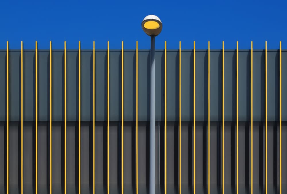 Yellow Fence Blue Sky by Hans-Wolfgang Hawerkamp — canvas wall art
