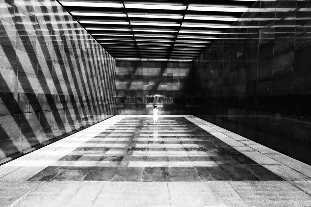 Lone Figure Geometric Shadows by Marius Cinteza — canvas wall art