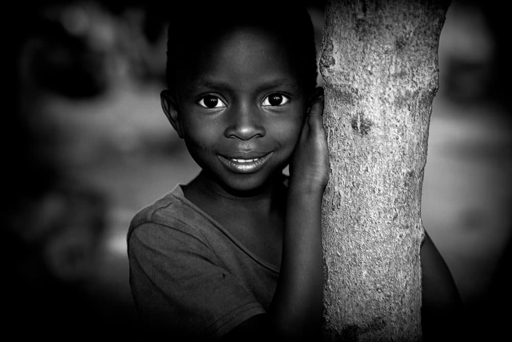 Smiling Boy By Tree by Joxe Inazio Kuesta Garmendia — canvas wall art
